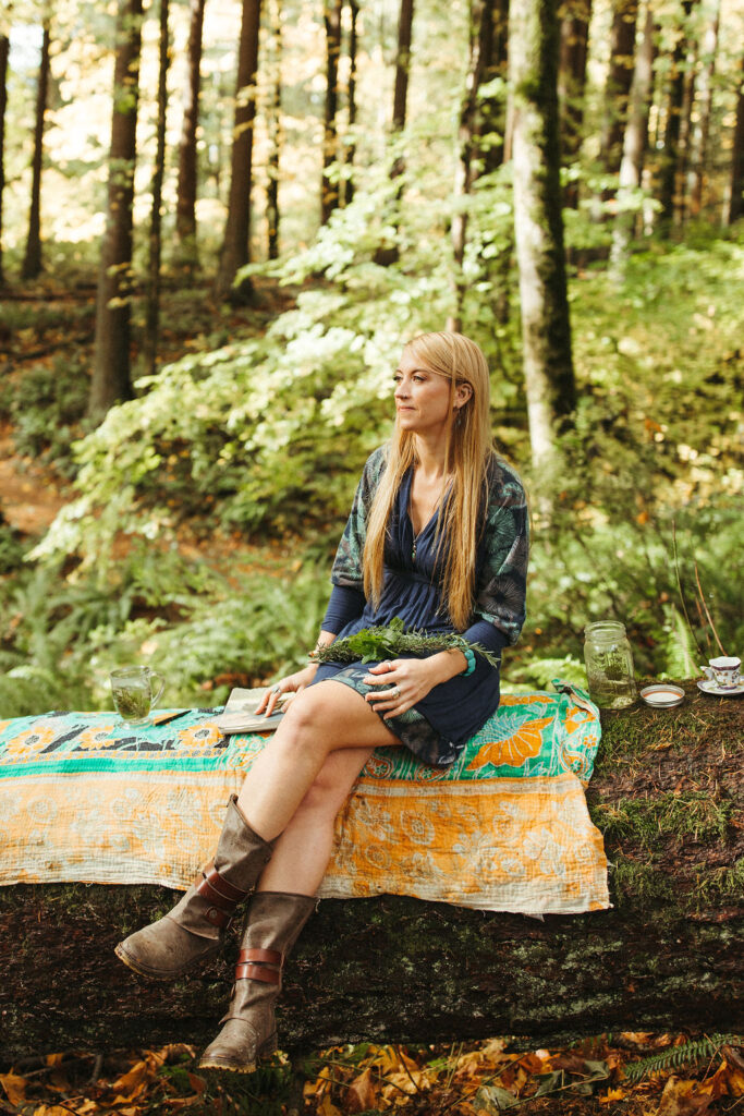 Herbal Support through Therapy. Support container through therapy. Lindsey Walker sitting on a log in Forest Park, OR. Mockingbird Remedies.